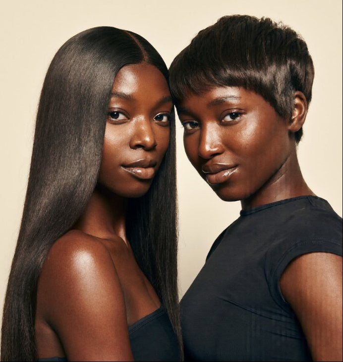 Two women with sleek, straight hair styled with Silky Straight